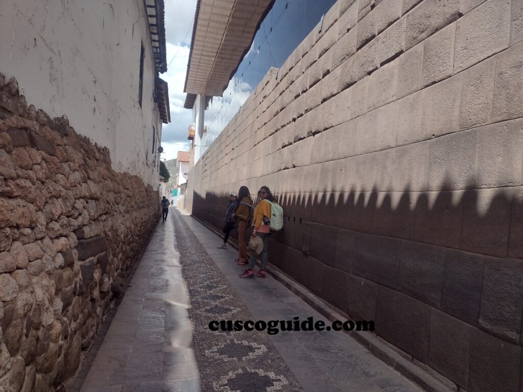 Ahuacpinta Street in Cusco, featuring the perfectly fitted Inca stone wall of the Sun Temple, or Qoricancha.
